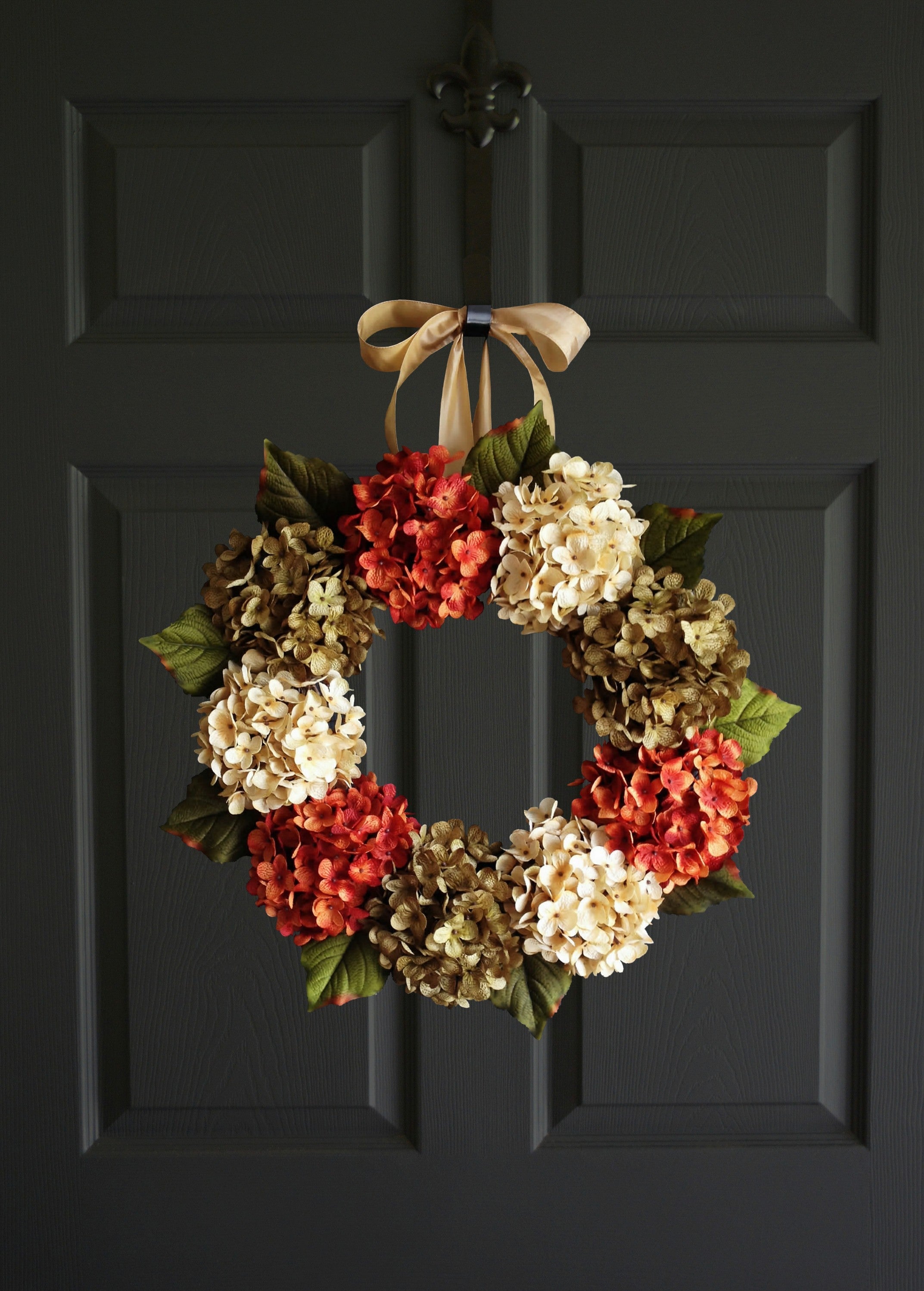 fall hydrange door wreath in orange, green and cream colors pn a front door