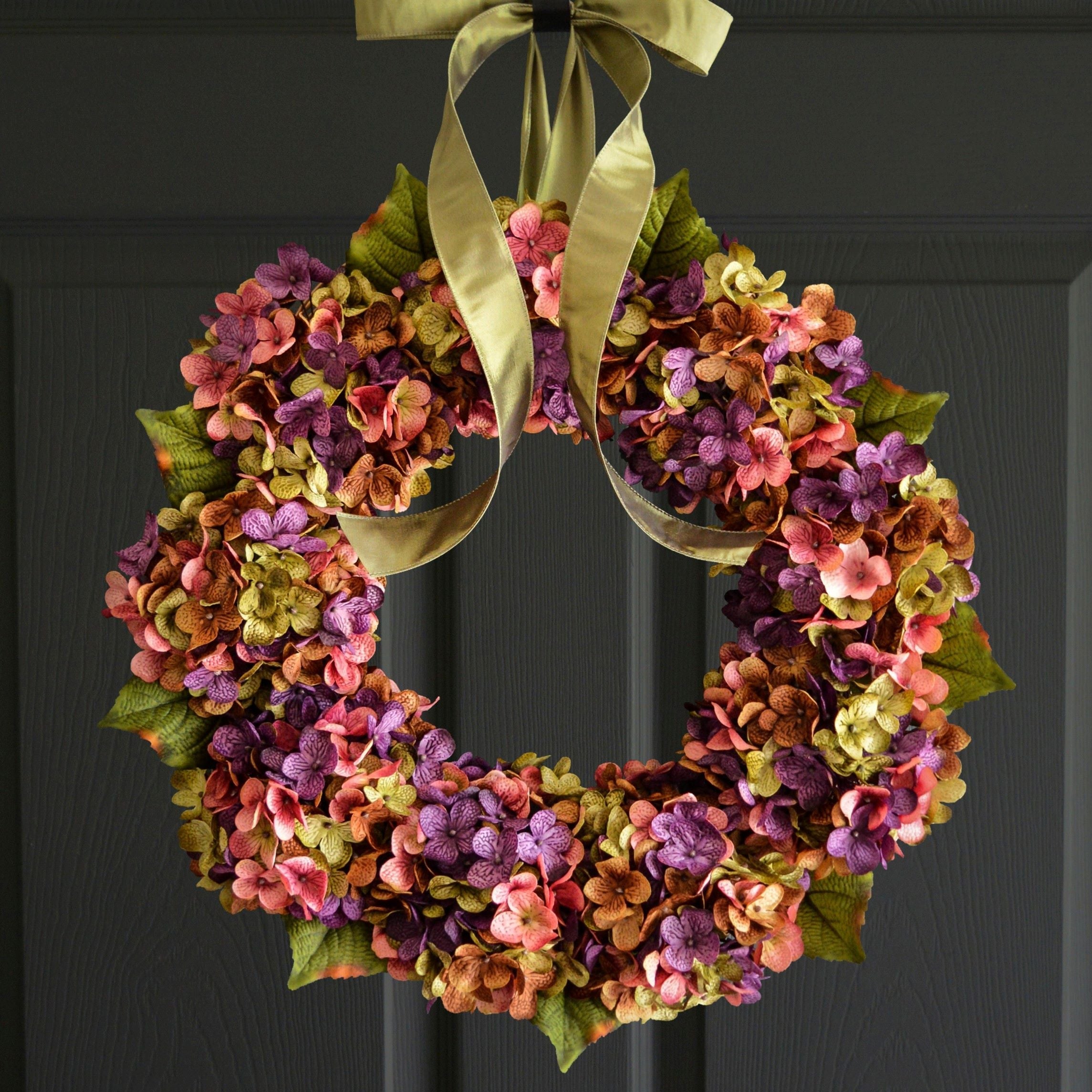 front door wreath with lush hydrangea flowers in soft seasonal colors on grapevine base