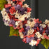 Close up of coral and lavender faux hydrangea blooms in handcrafted spring wreath