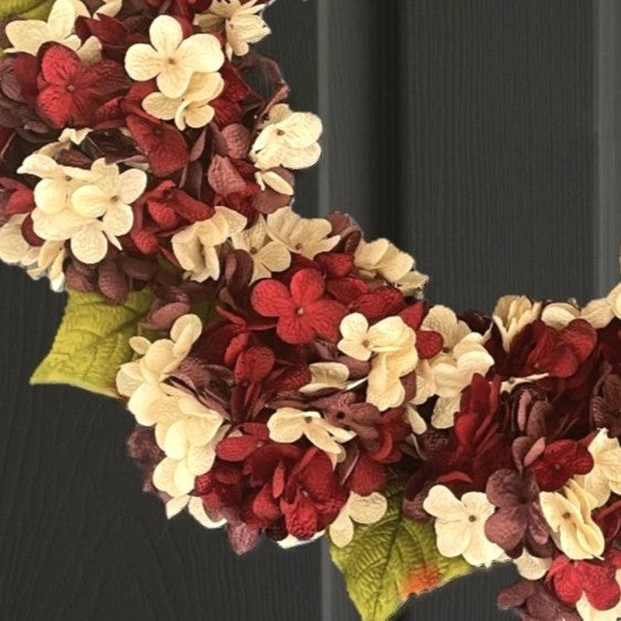 Close-up of premium handcrafted floral wreath with plum burgundy blooms