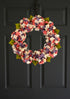 Coral and lavender hydrangea wreath displayed on front door for spring farmhouse decor