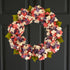 Spring hydrangea wreath for front door in coral and lavender pastel flowers with lush greenery