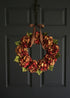 fall hydrangea door wreath in brown and red colors on front door