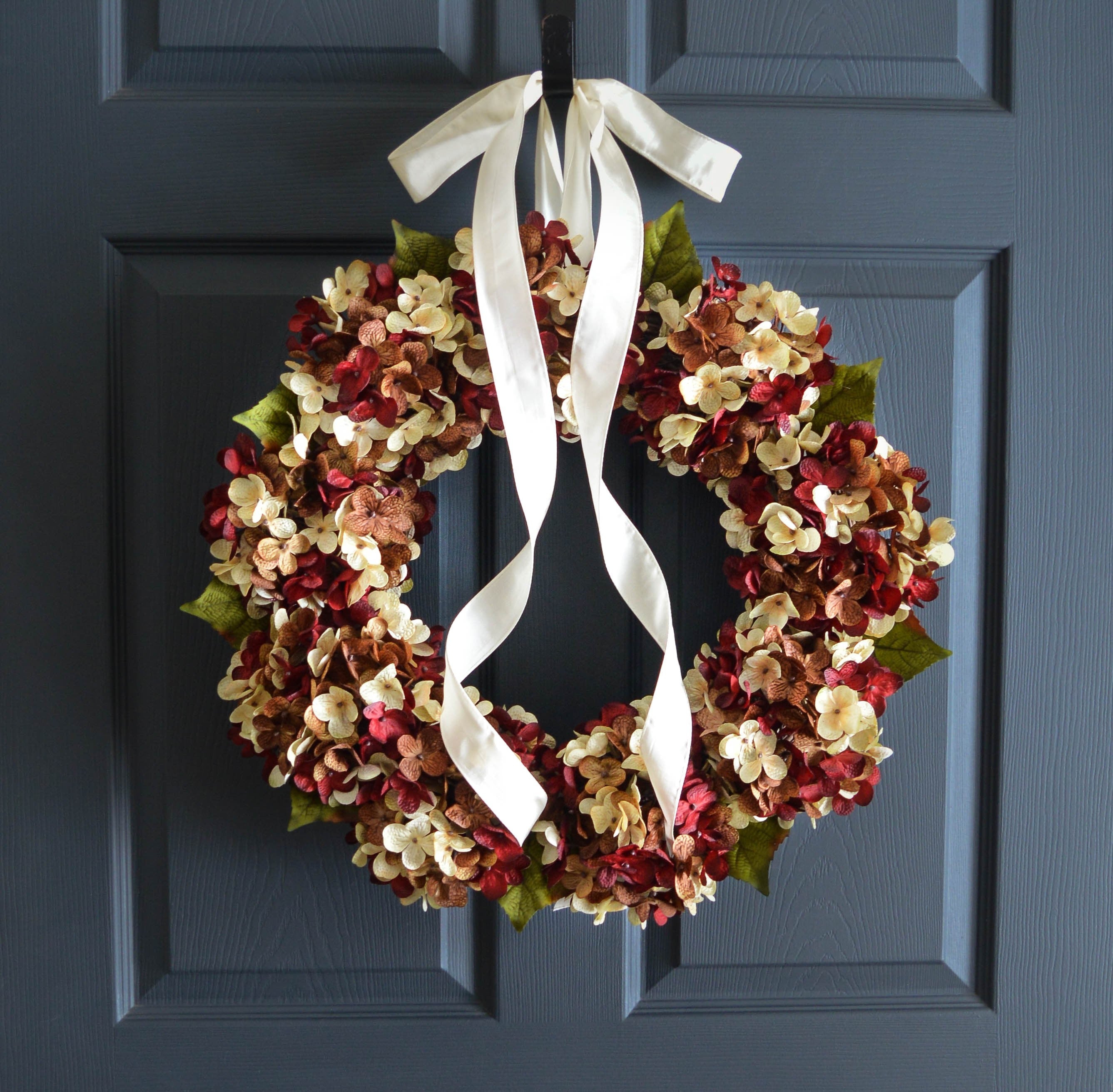 Elegant hydrangea wreath hanging on a covered porch