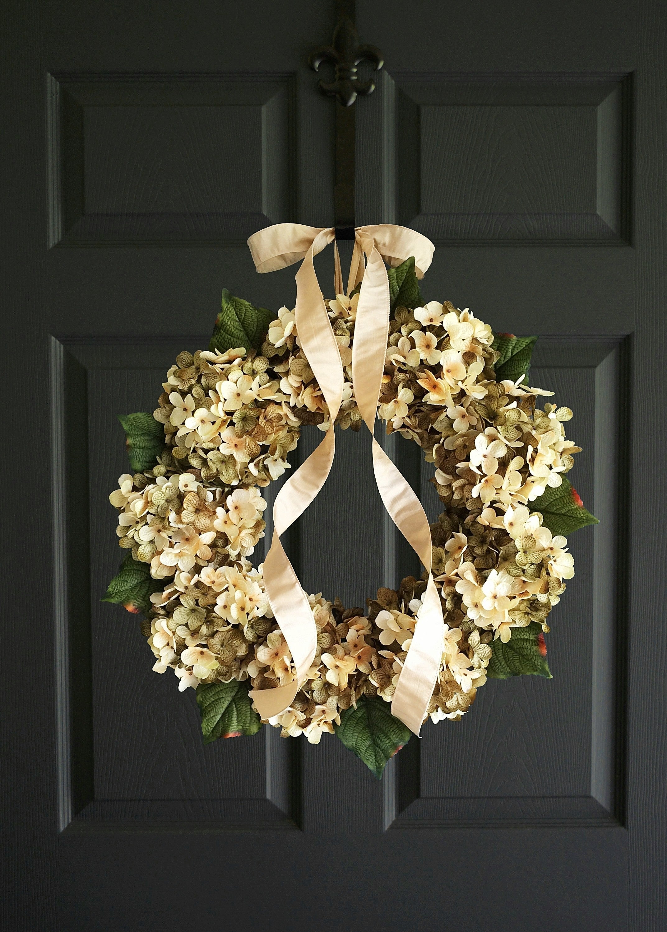 green hydrangea wreath on dark door