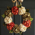 fall hydrange door wreath in orange, green and cream colors