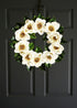 magnolia flower wreath on dark door