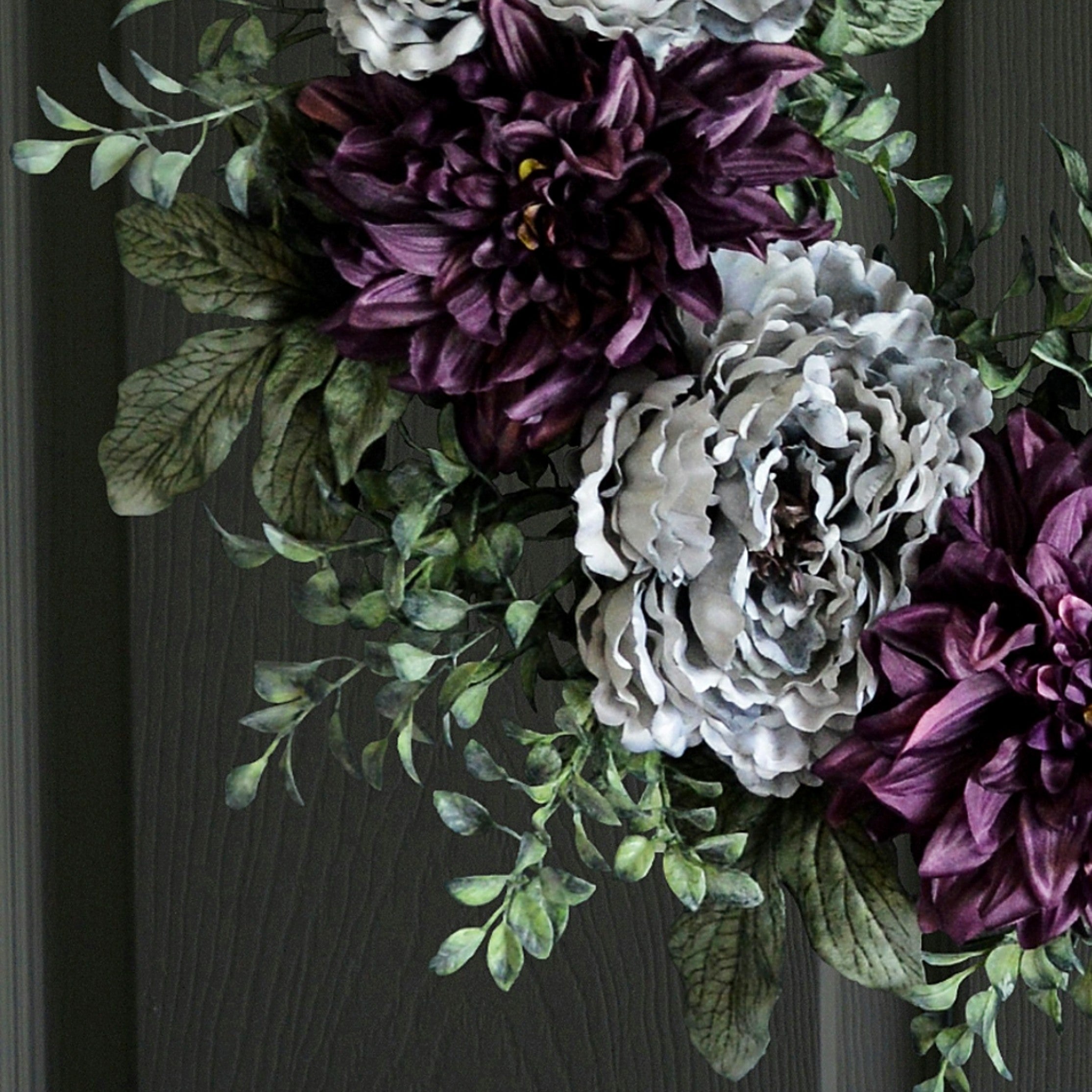 peony wreath gray purple on dark door closeup