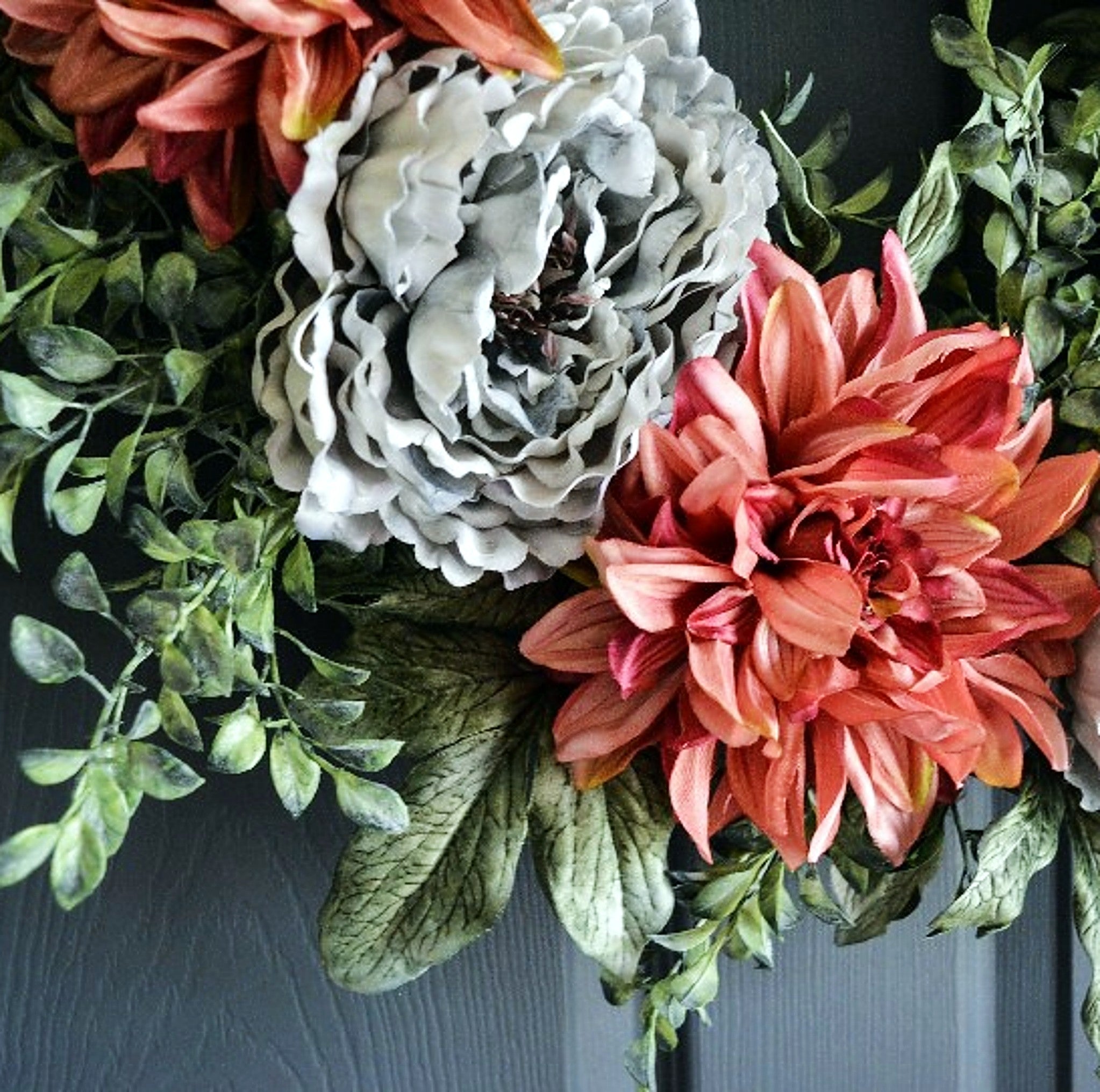 peony and dahlia wreath on a dark door closeup photo