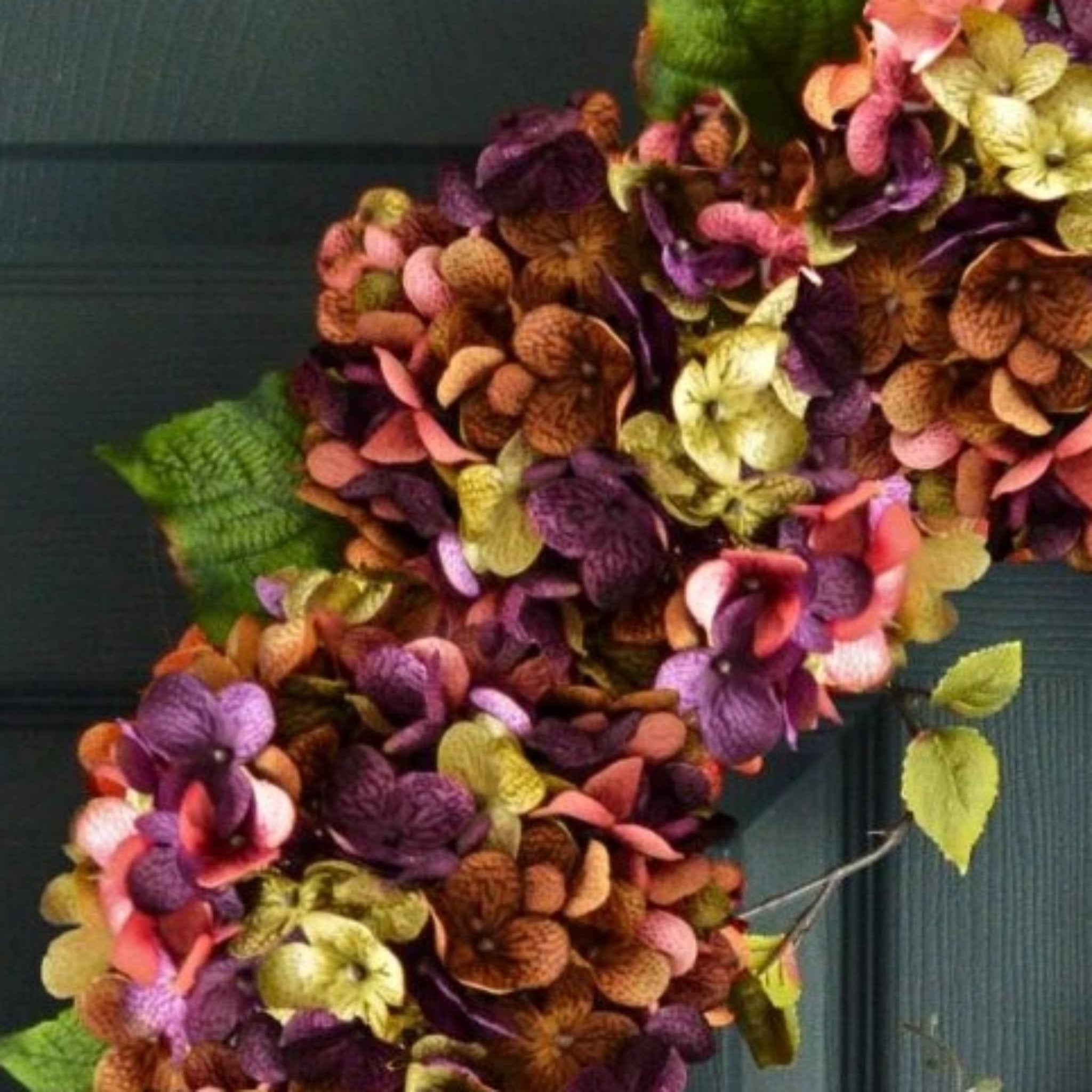 Close up of premium silk hydrangea flowers on large oval spring wreath, realistic floral craftsmanship