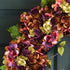 Close up of premium silk hydrangea flowers on large oval spring wreath, realistic floral craftsmanship