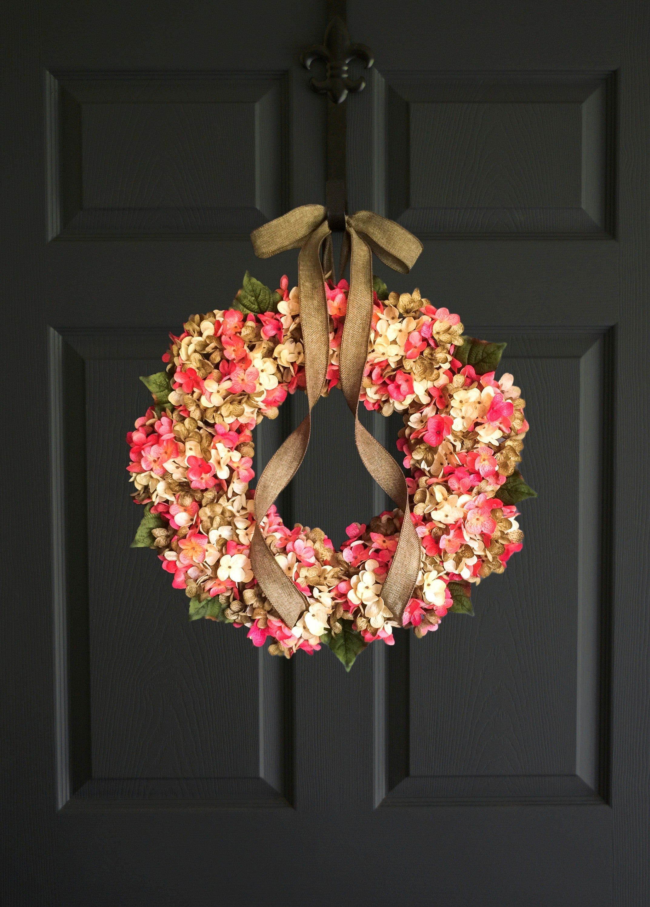 Spring hot pink wreath displayed on front door for bright seasonal decor