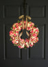Spring hot pink wreath displayed on front door for bright seasonal decor