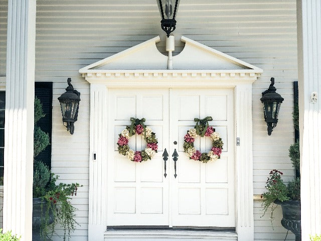 hydrangea wreaths on white doors